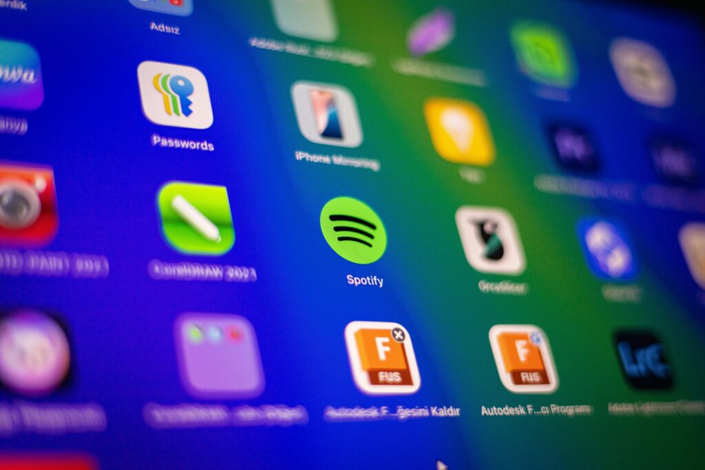 pexels-photo-31113917-31113917 Blurred close-up of vibrant app icons on a smartphone screen showcasing Spotify and more.